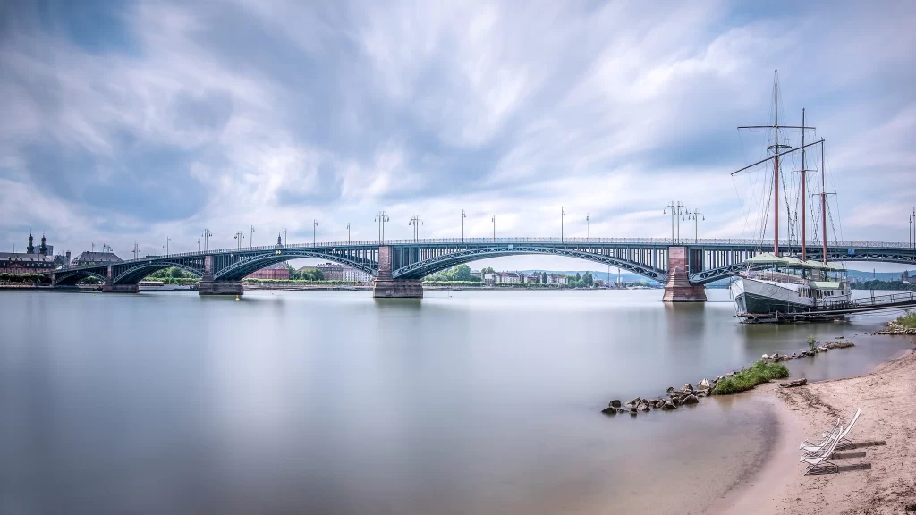 bridge water boat sky clouds shore