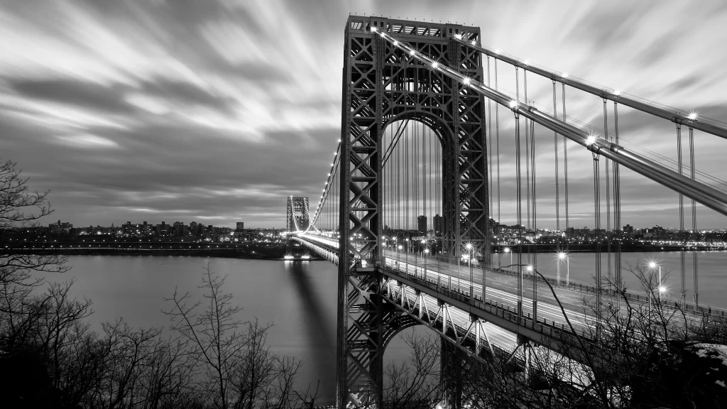bridge water city lights clouds black and white