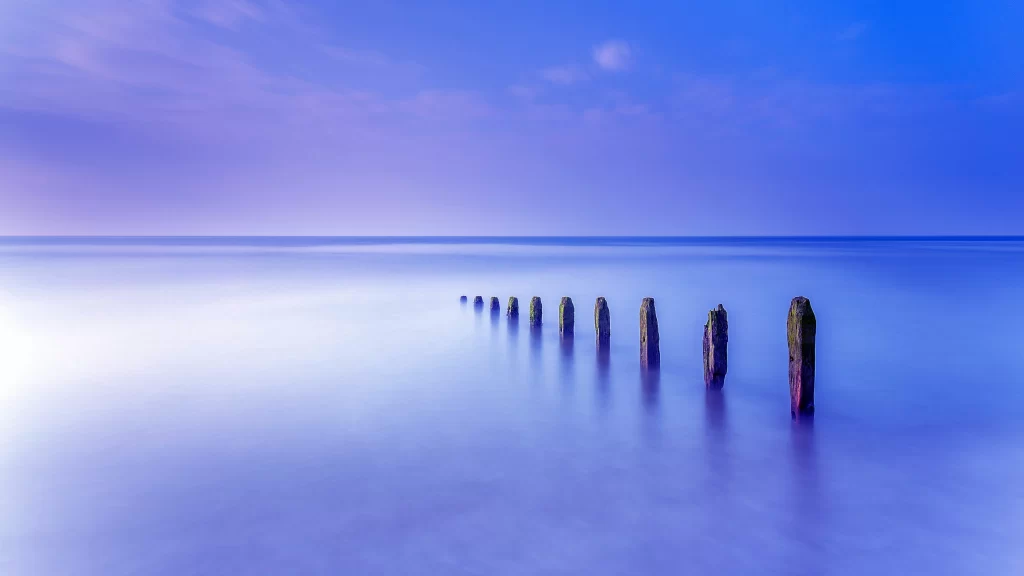 calm water, wooden posts, twilight, serene, reflection, tranquility