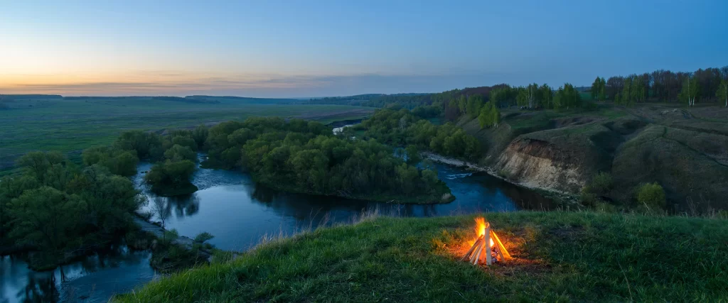 campfire nature landscape twilight river trees