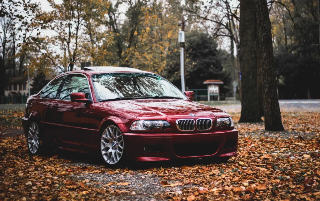 car autumn leaves red BMW trees