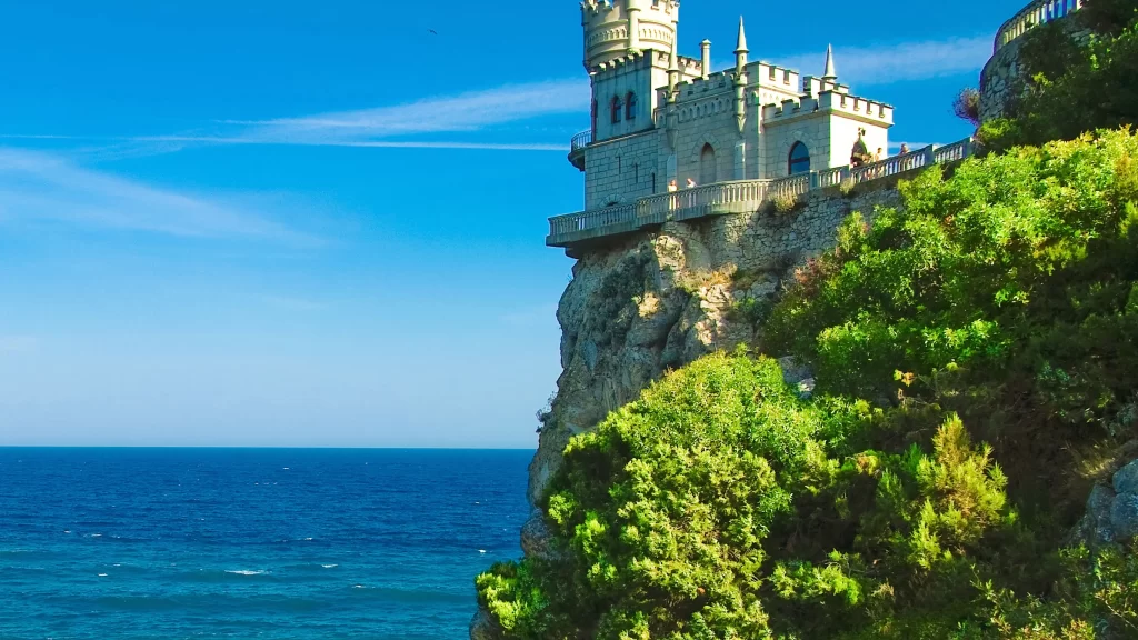 castle ocean cliff blue sky greenery