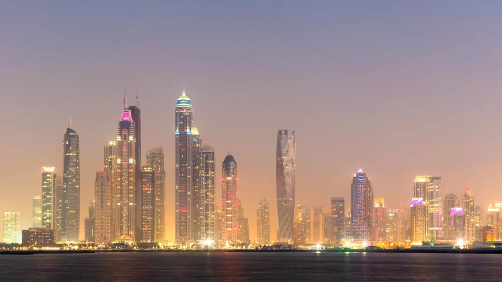 city skyline skyscrapers lights water twilight urban