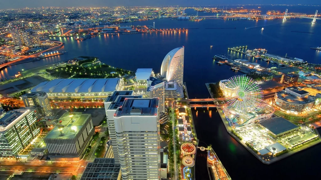 cityscape night lights buildings water Ferris wheel bridge urban
