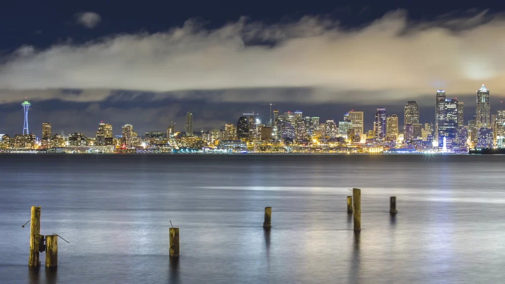 cityscape skyline waterfront night lights clouds reflection urban