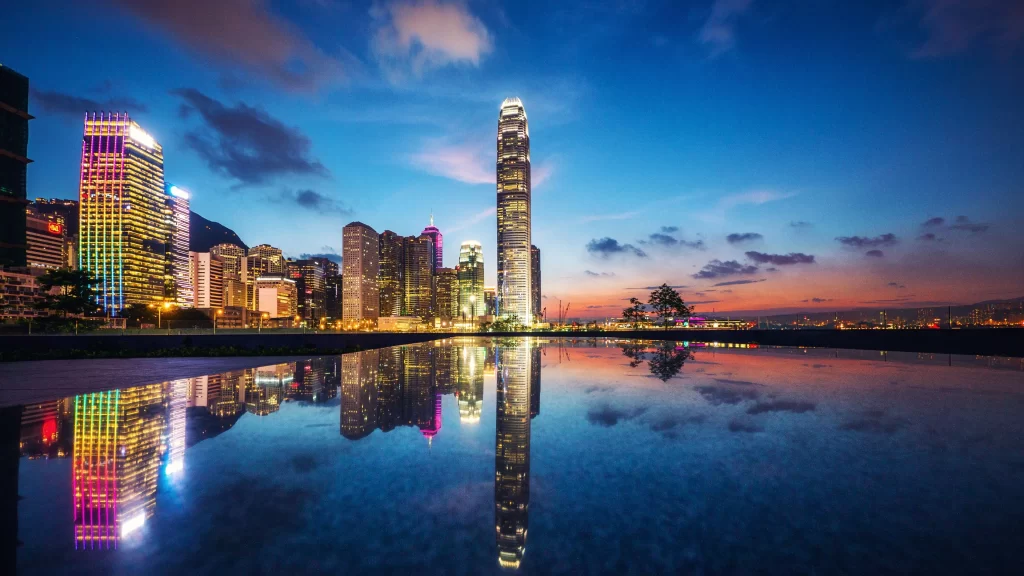 cityscape skyscrapers reflection sunset water lights