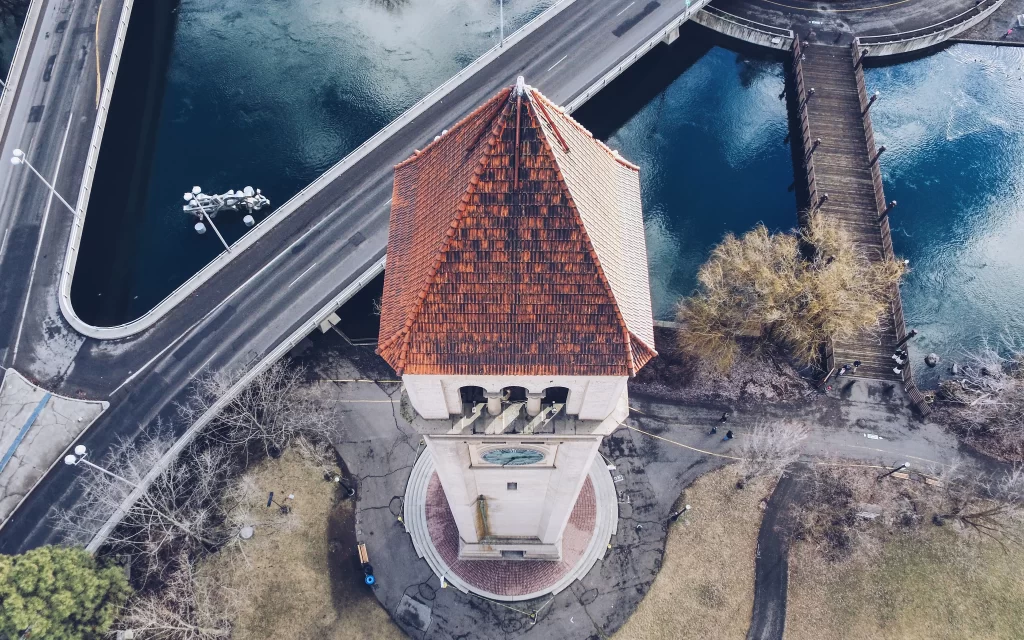 clock tower aerial view bridge water road trees