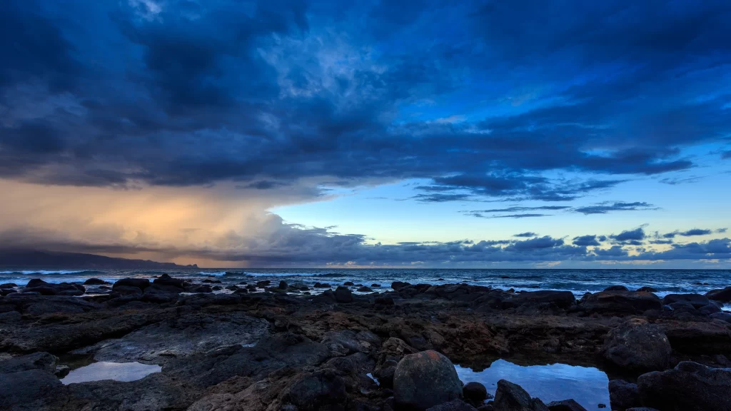 clouds ocean sunset rocks water