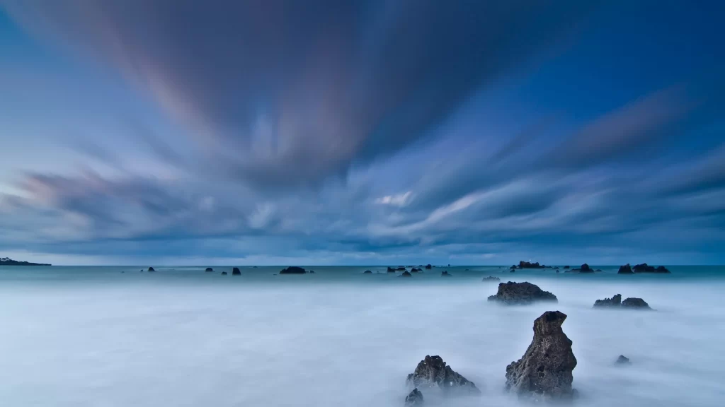 clouds sky ocean rocks waves horizon