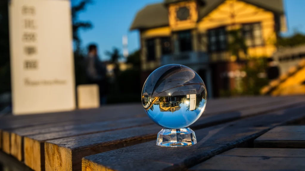 crystal ball reflection wooden bench building sign sunlight