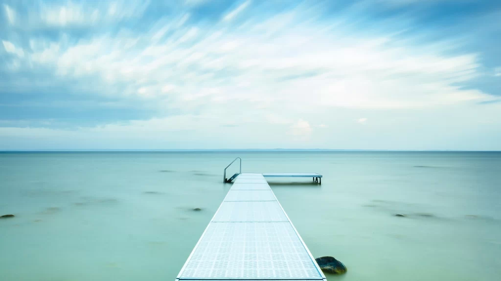 dock water sky clouds horizon tranquility