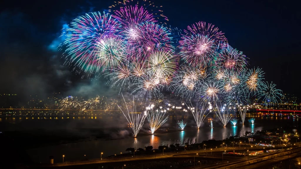 fireworks night city celebration water reflection
