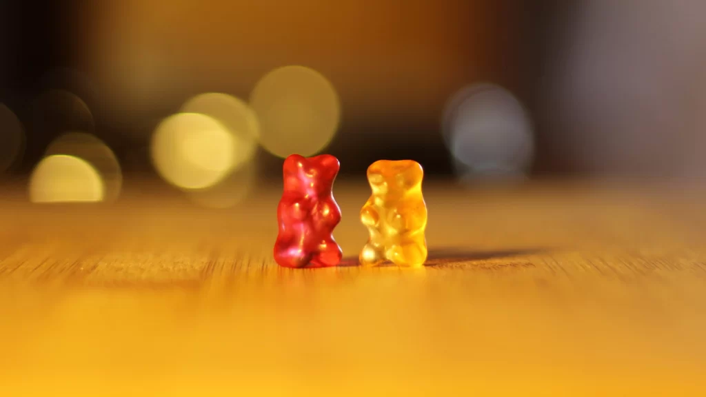 gummy bears, colorful, wooden surface, blurred background, playful