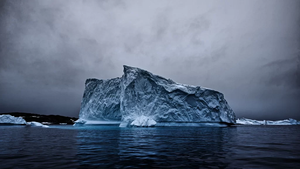 iceberg ocean clouds sky water reflection
