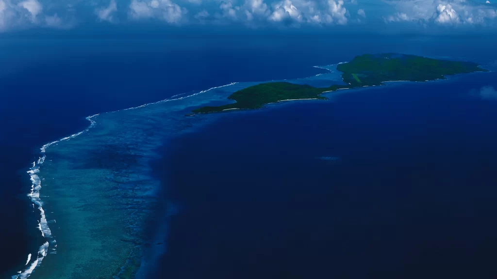 island ocean coastline waves clouds sky