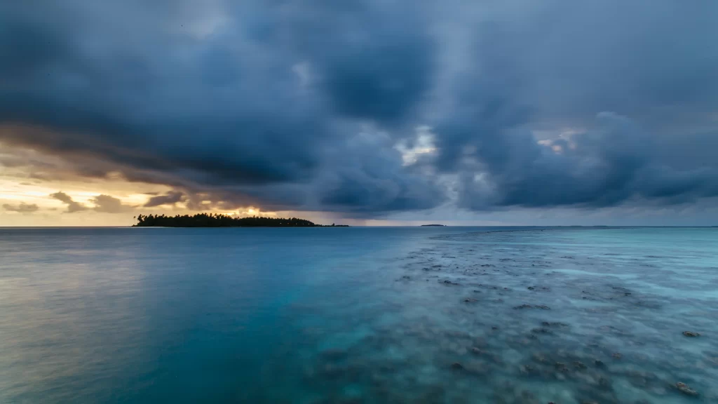 island ocean sunset clouds horizon calm