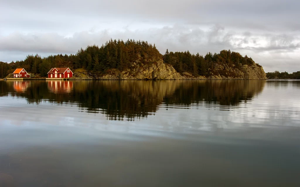 lake reflection houses trees sky clouds