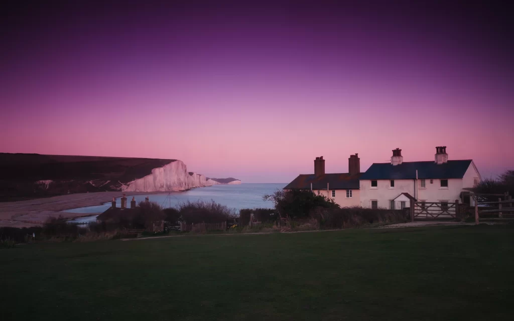 Sunset Purple Houses Cliffs Ocean Grass