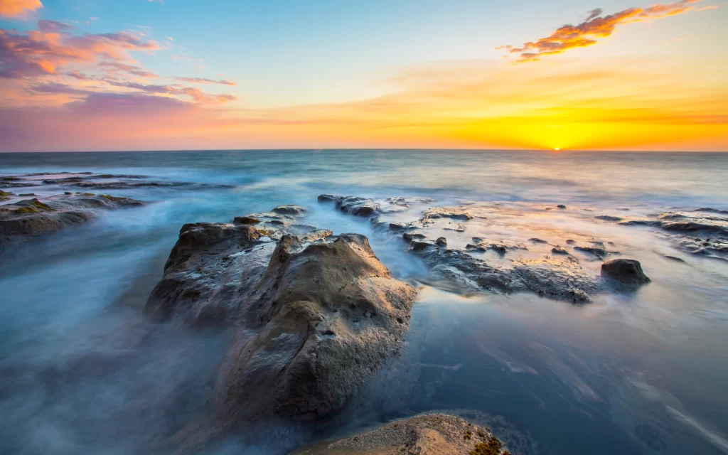 Sunset Ocean Waves Rocky Shoreline Clouds