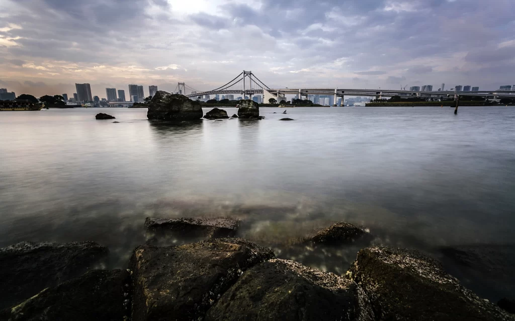 Bridge Water Rocks Cityscape Sky Clouds