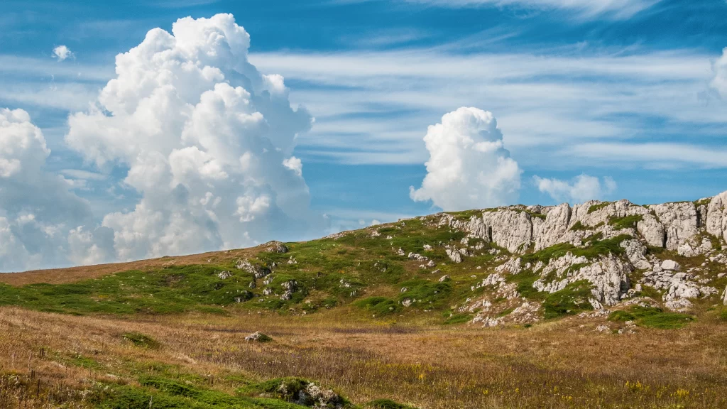 landscape grass rocks sky clouds nature