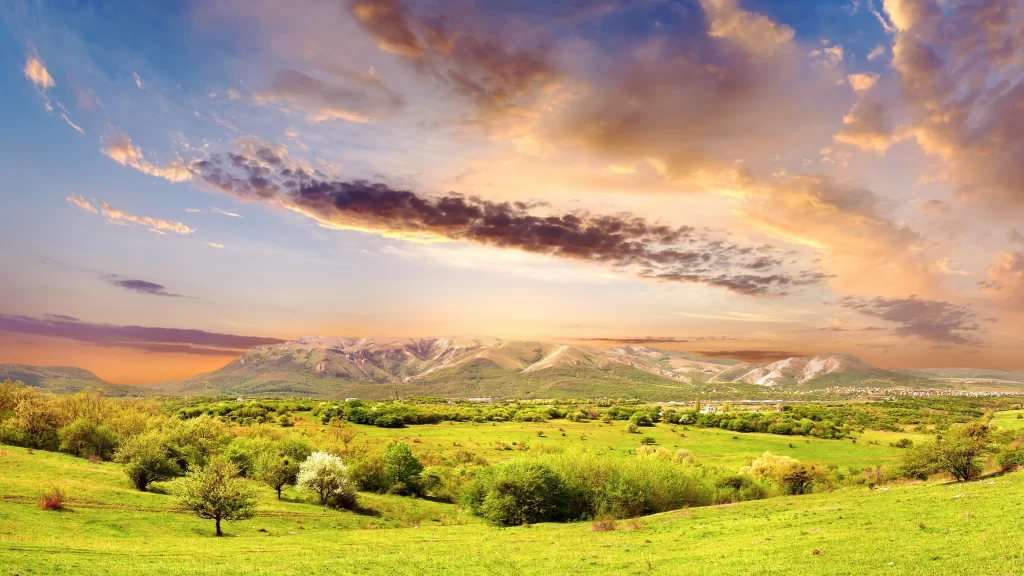 landscape nature sunset clouds green hills trees sky