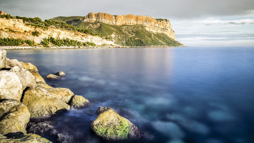 landscape sea rocks cliffs sky vegetation