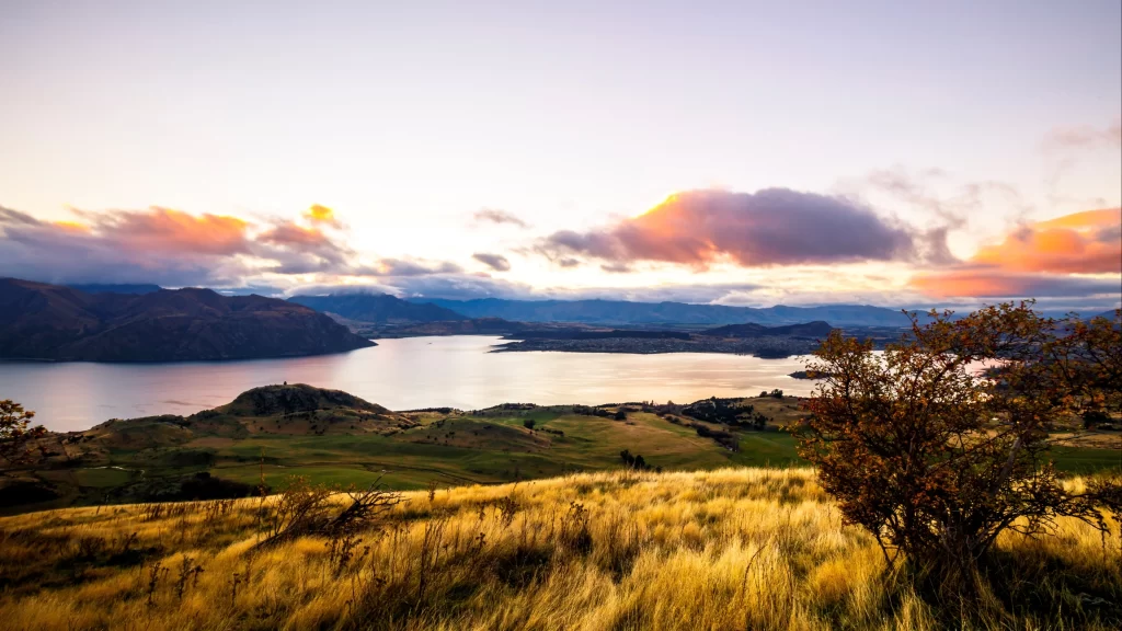 landscape sunset clouds lake hills grass