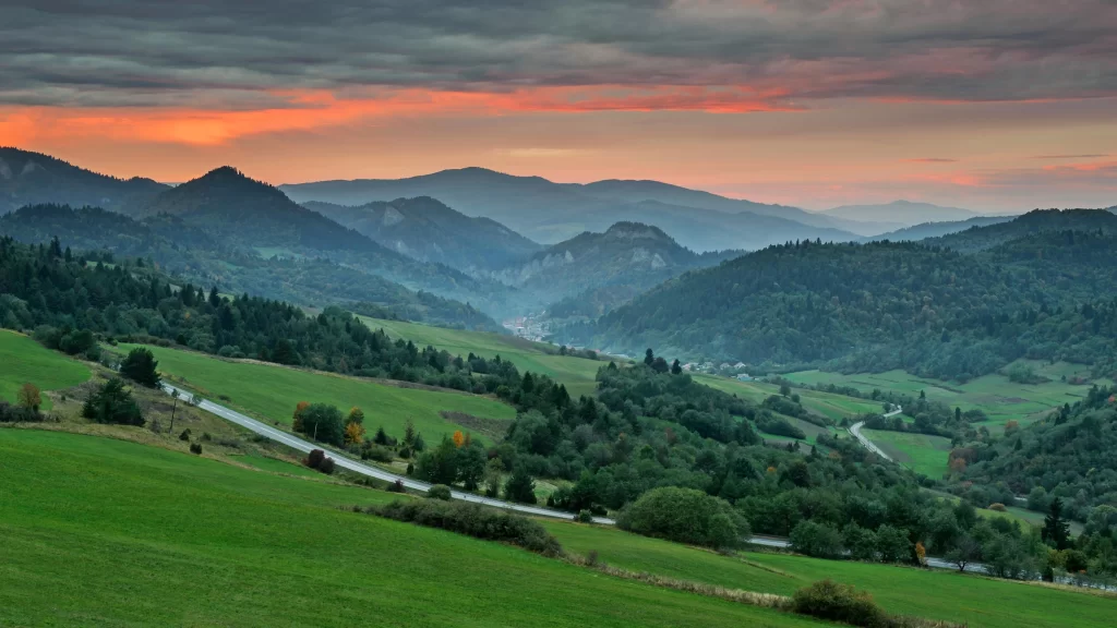 landscape sunset mountains green sky clouds