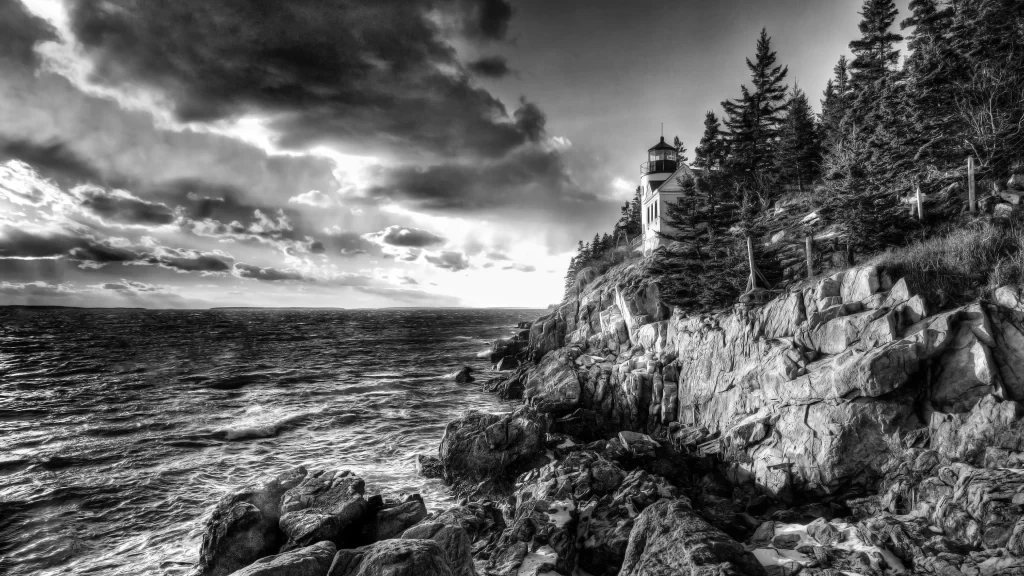 lighthouse rocky coast ocean trees clouds sunset