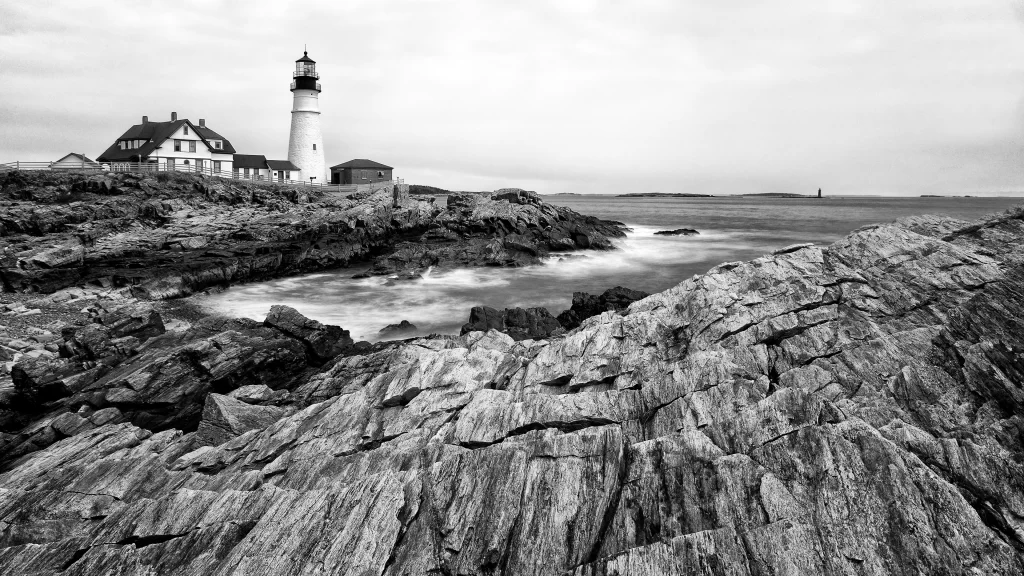 lighthouse rocky coast ocean waves black and white