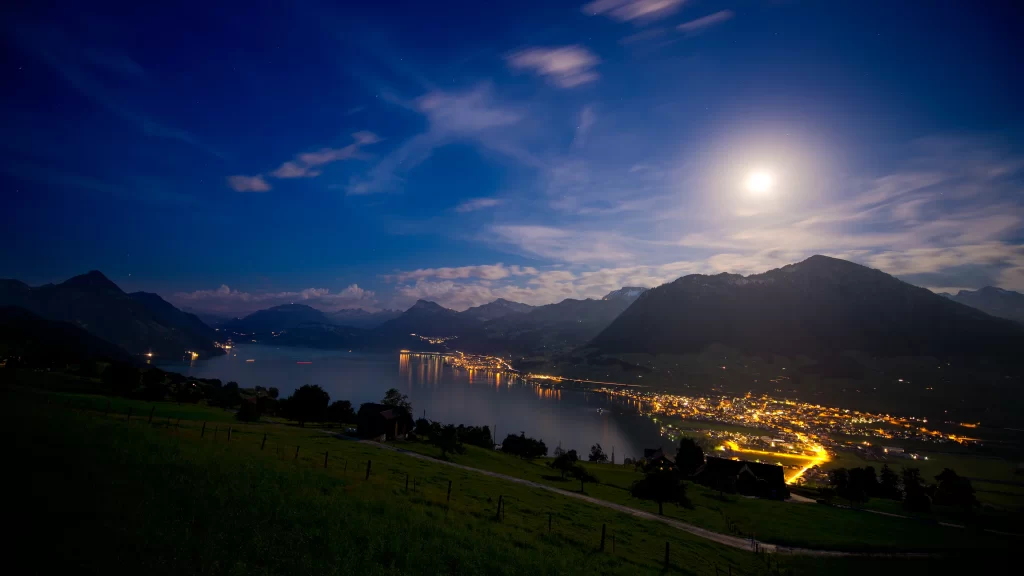 moon night landscape lake city mountains