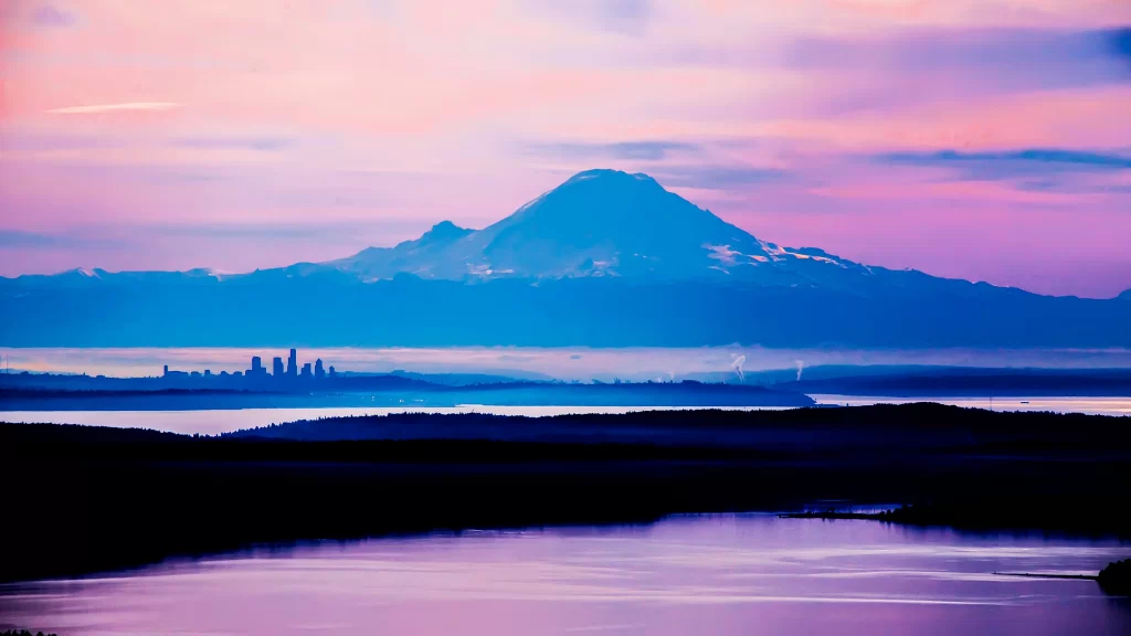 mountain city skyline water sunset