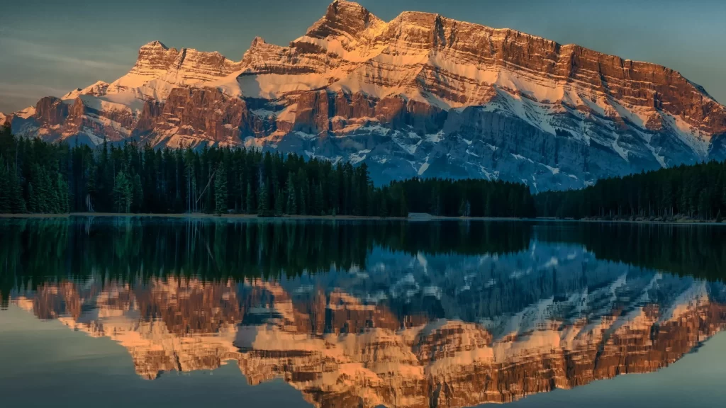 mountain lake reflection sunrise snow forest
