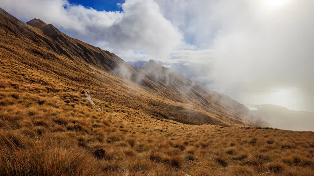 mountain landscape grass clouds sunlight