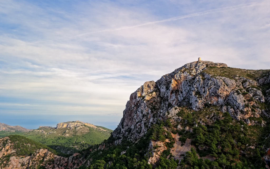 mountain landscape rocky terrain greenery sky clouds