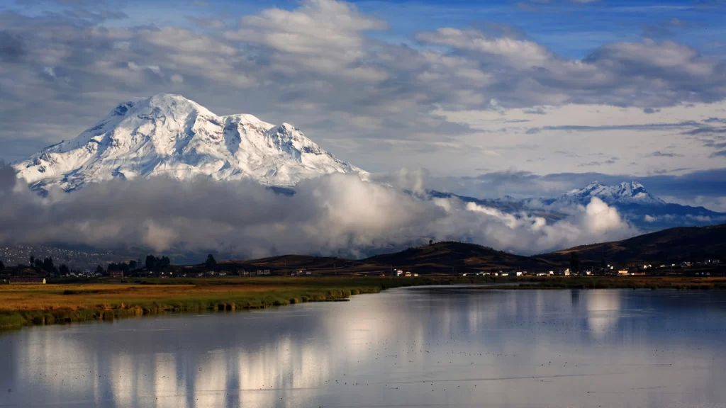 mountain snow clouds lake reflection