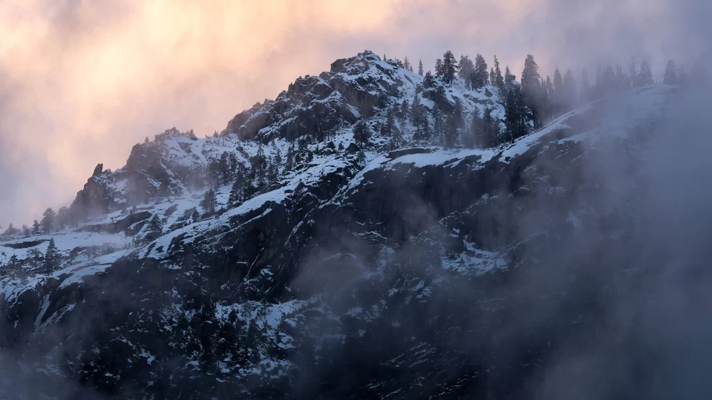 mountain snow clouds trees rocky landscape