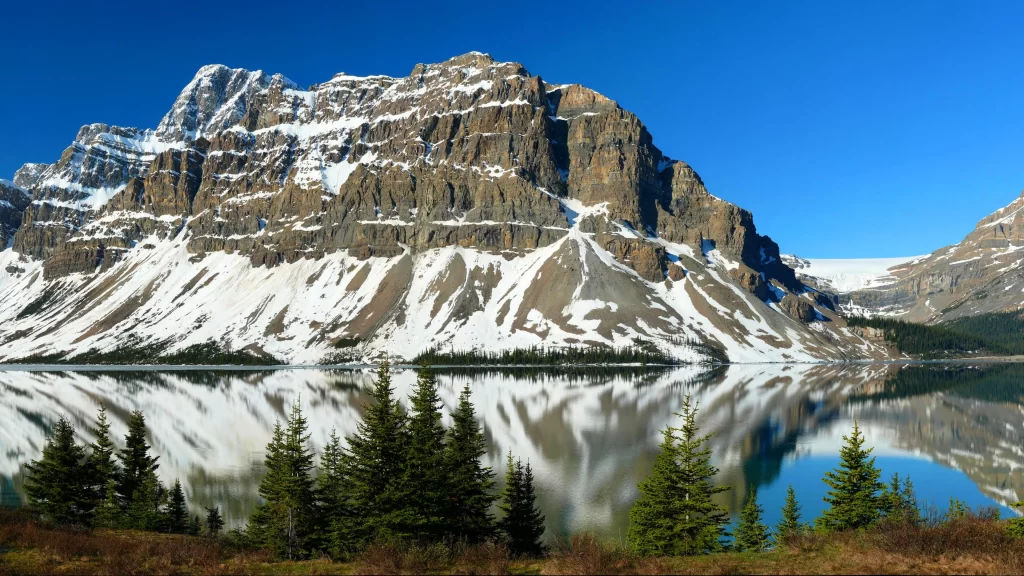 mountain snow lake trees sky