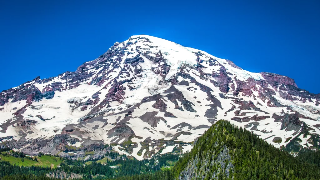 mountain snow peak blue sky forest green
