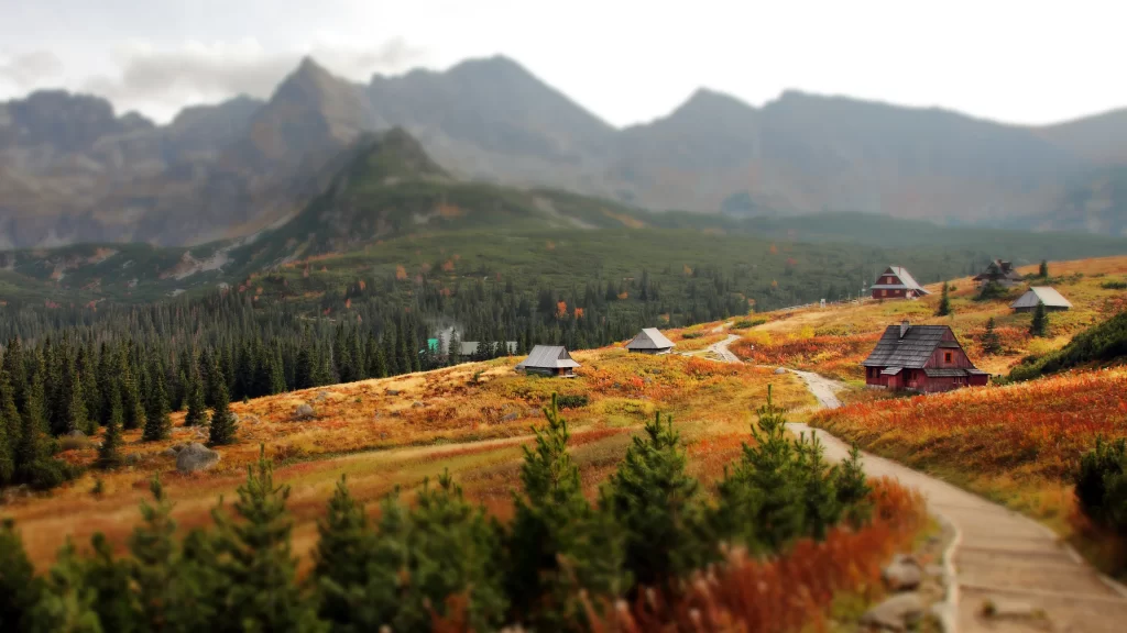 mountains houses path autumn trees landscape
