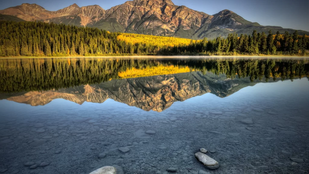 mountains lake reflection forest rocks