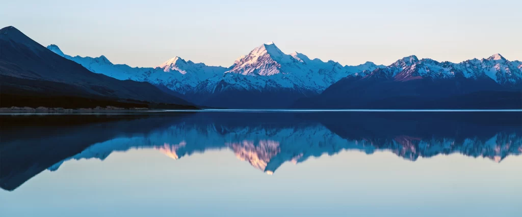 mountains lake reflection snowscape serene