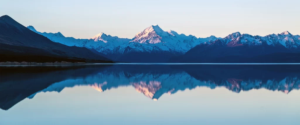 mountains lake reflection snowscape serene