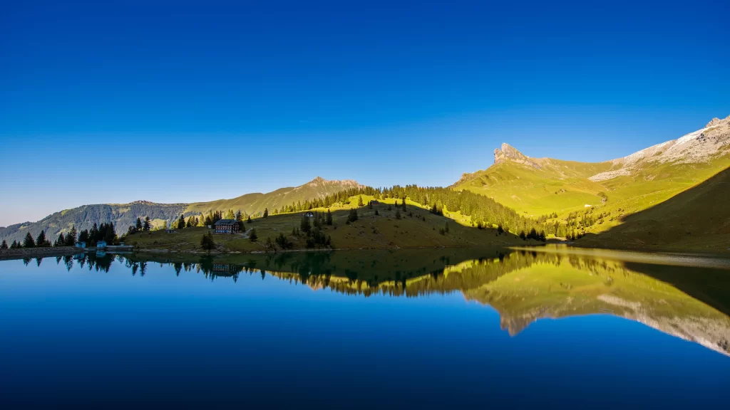 mountains lake reflection trees sky