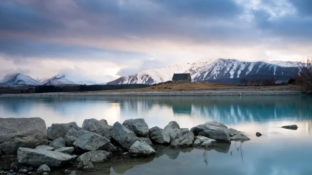 mountains lake rocks reflection clouds