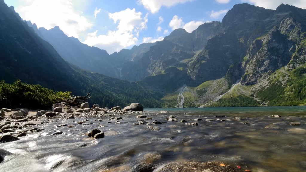 mountains lake rocks water sky