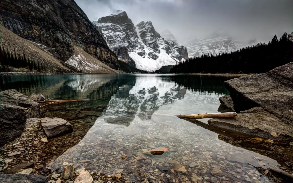 mountains lake snow reflection forest rocks