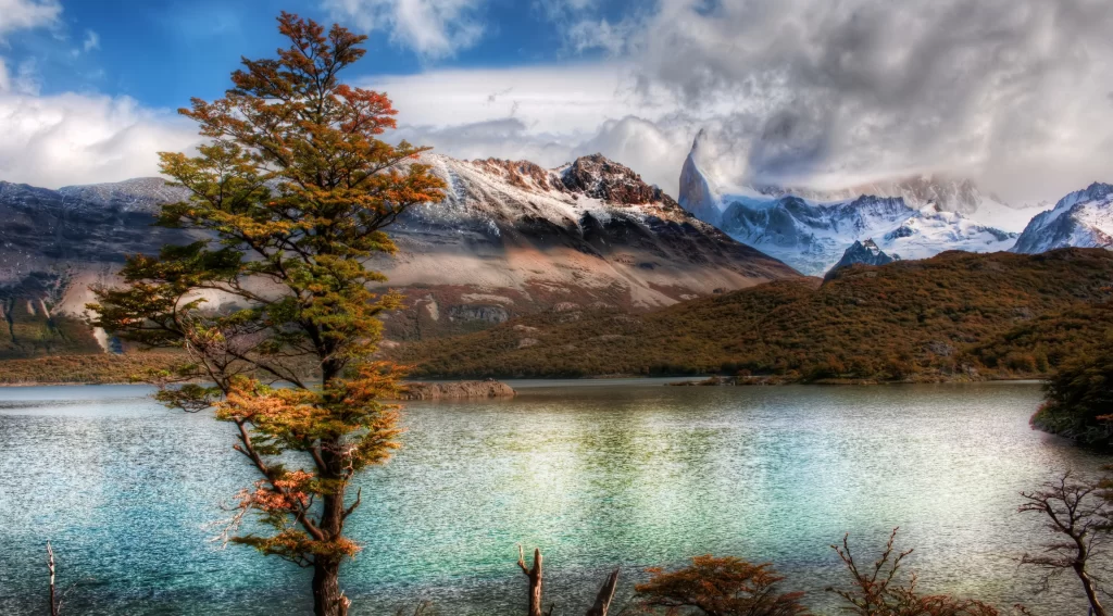 mountains lake tree snow clouds