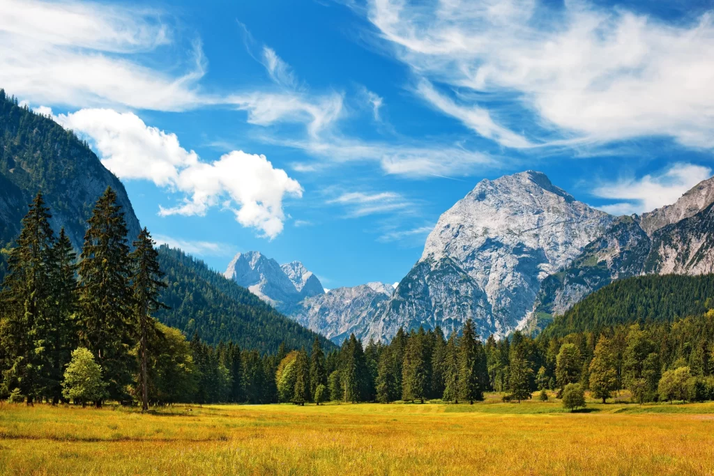 mountains sky clouds trees grass landscape